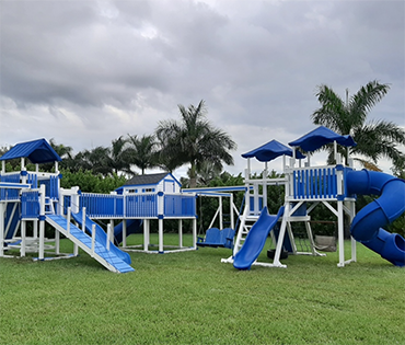 Large Swing Kingdom vinyl playset in Plantation, Florida, installed by Play King.
